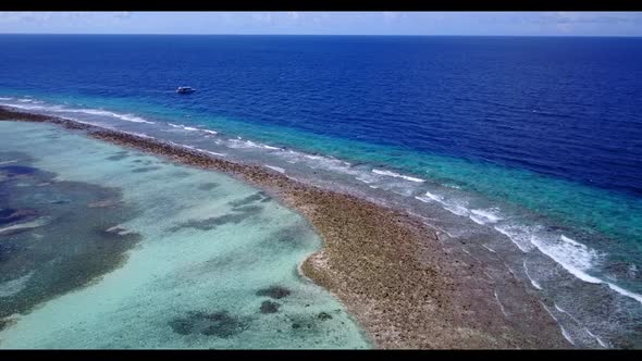 Aerial drone shot abstract of idyllic shore beach adventure by blue green water with clean sandy bac