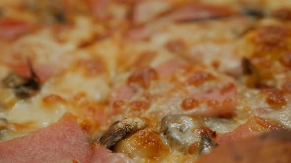 Tasty pizza taken from oven slow tilting  4K 3840X2160 UHD footage - Shallow DOF pizza details slow 