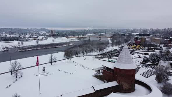 Aerial side shot of Kaunes Castle in cold and snowy winter season