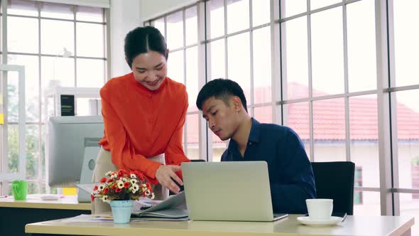 Two Business People Talk Project Strategy at Office