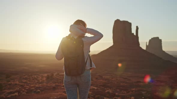 Nature Background  Traveler Woman with Backpack Monument Valley at Sunset USA