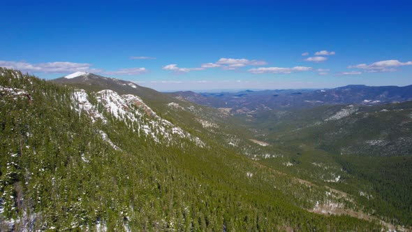 HD Drone Shot Of Beautiful Lush Green Large Wide Open Alpine Rocky Mountains Valley During Sunny Vib