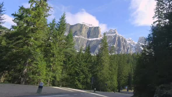 Fast driving through the winding road from the peak to down in Dolomites, Italy