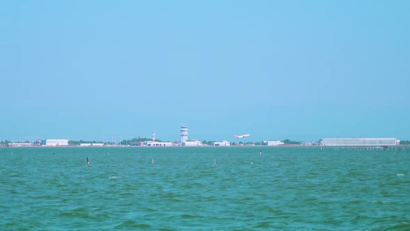 View of Venecian Airport From Lagoon with Taking Off Plane