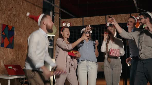 Office Employees Are Celebrating Christmas Man Is Trying To Blow a Cracker