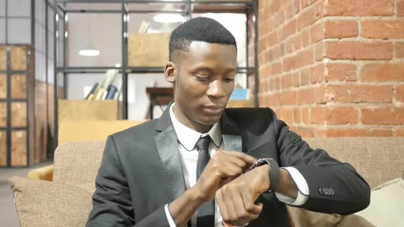 Black Businessman Using Smartwatch, Office