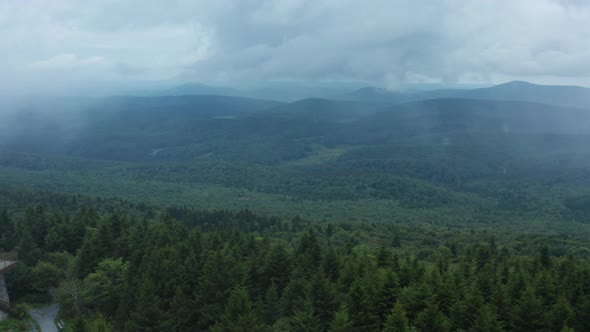 An aerial shot (dolly in) of the Seneca Creek Valley and the lookout tower on top of Spruce Knob, th