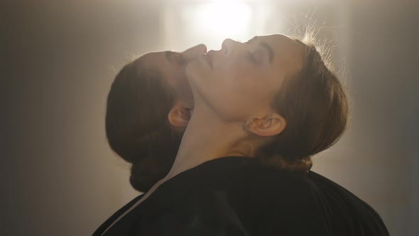 Closeup of Beautiful Female Dancers Putting Head on Shoulders of Each Other One Looking at Camera