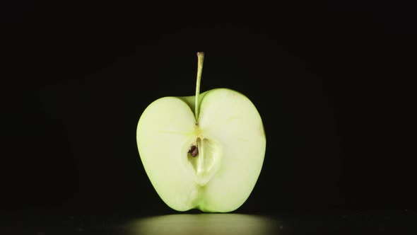 Human Hand Takes Away A Half Of Green Apple