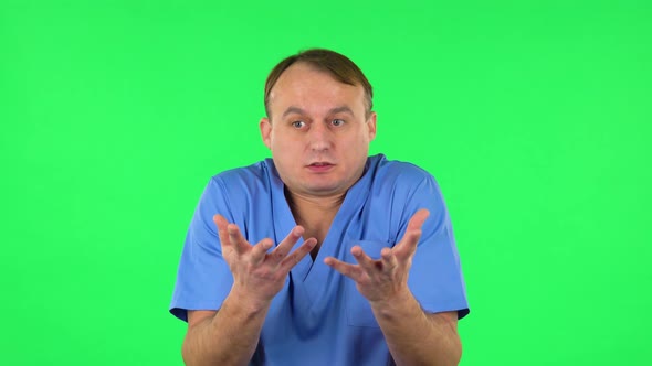 Displeased Man Indignantly Talking To Someone, Looking at the Camera. Green Screen