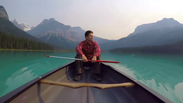 Man sitting on boat in lake 4k