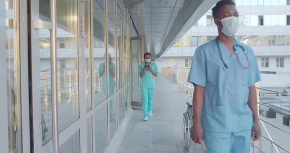 Multiethnic Medical Workers Wearing Safety Mask Walking Outdoors Hospital Building