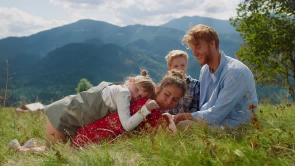 Happy Family Relaxing Grass at Sunny Day