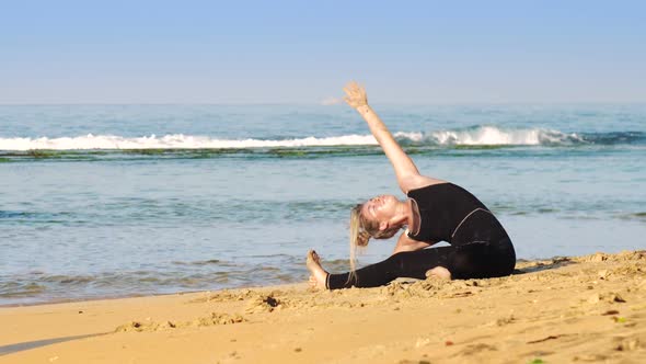 Girl in Black Tracksuit Practices Stretching Yoga Poses