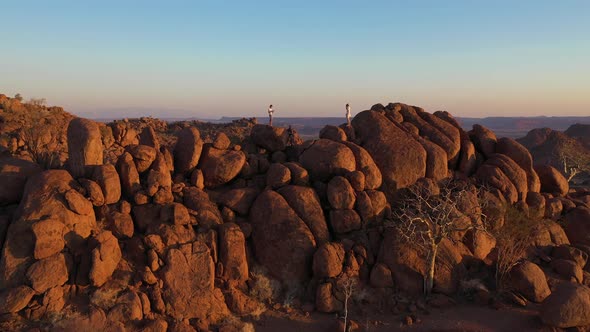 Aerial view of two person standing on the cliff top in Damaraland, Namibia.