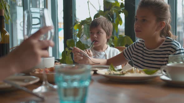 Children Are Eating at Family Lunch in a Cafe