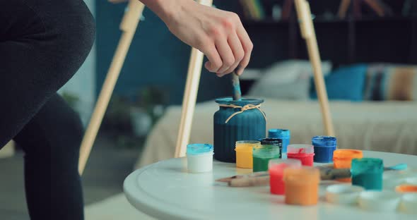 Artist Puts the Brush in a Jar of Water and Dunks It in Paint