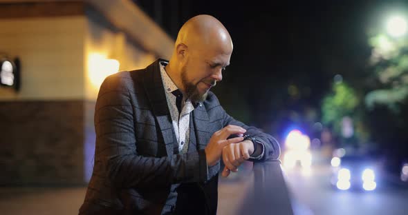 Businessman Using Smart Watch at the Night City