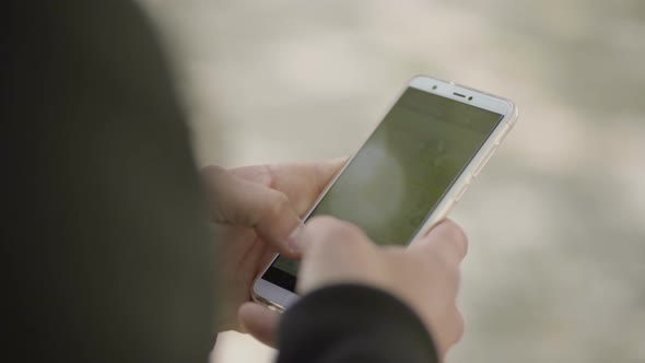 Cropped Shot of Man Messaging By Mobile Phone