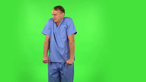 Medical Man Froze and Trying To Keep Warm Against Green Screen