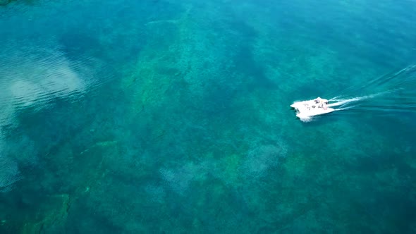 Aerial, Top Drone Scene of Catamaran Anchored in a Bay with Transparent Turquoise Water and