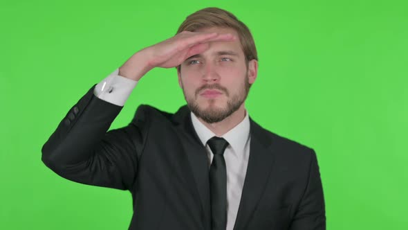 Young Businessman Looking Around Searching Green Screen