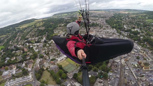 Paraglider Pilot Enjoys Flight Over Coastal Seaside Resort
