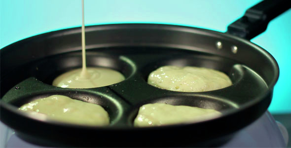 Cooking Pancakes on Pan. Dough Pouring on Frying Pan