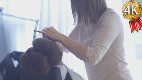 Female Stylist is Applying Makeup 