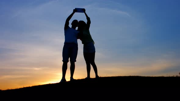 Lovers Do Selfie at Sunset