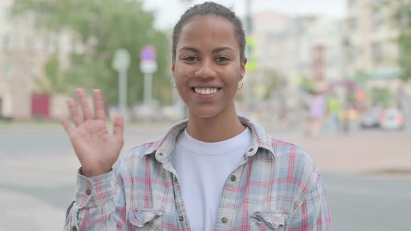 Welcoming African Woman Waving Hand for Hello Outdoor