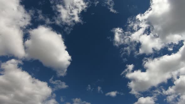 Clear blue sky with white clouds. Time lapse