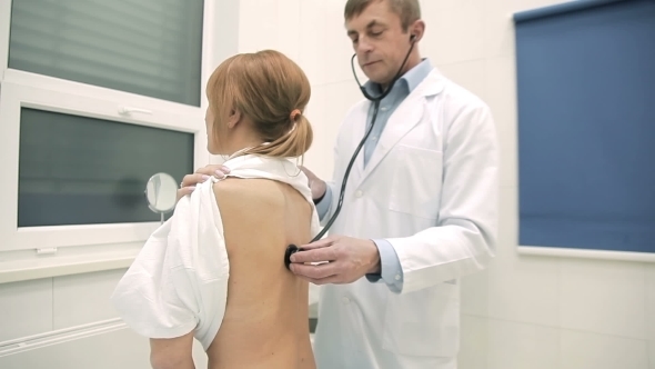 Doctor Checking Patient's Lungs Using Stethoscope alt