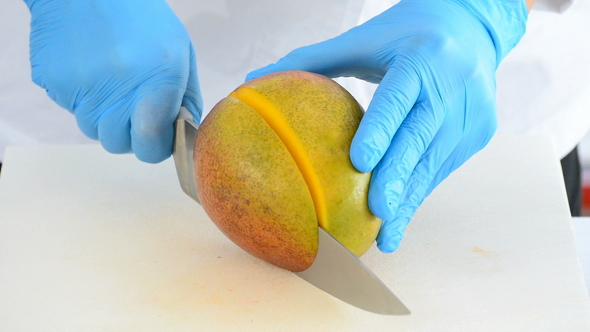 Cutting a Mango Fruit into Small Dices with a Knife