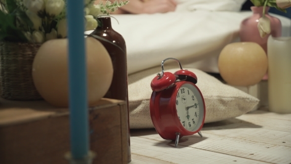The Woman Turns Off The Alarm And Hides It Under The Pillow alt