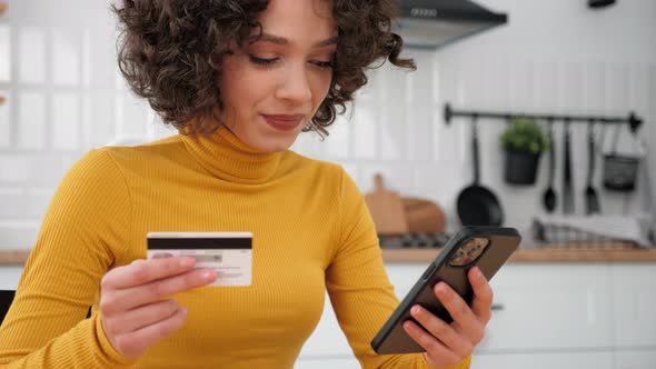 Close Up Woman Enters Credit Card Code to Pay Gifts Online Shopping Smartphone