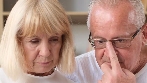 Closeup Portrait of a Retired Couple Looking at a Smartphone Screen