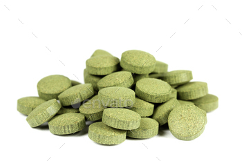 reen algae) C-vitamin tablets / pills. Isolated on white background.