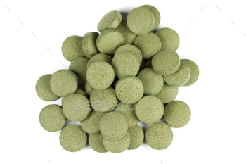 reen algae) C-vitamin tablets / pills. Isolated on white background.