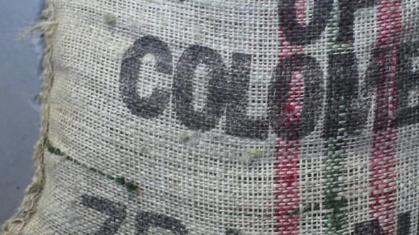 Bag With Coffee Grains in Coffee Factory Inscription Product of Colombia