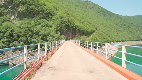 Bridge Over Beautiful Mountain Lake on a Sunny Day