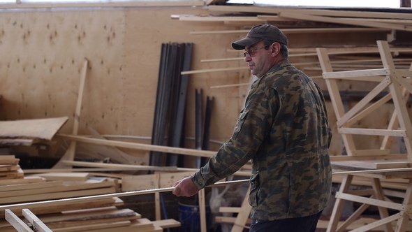 Carpenter Working with Circular Saw Woodworking Machine