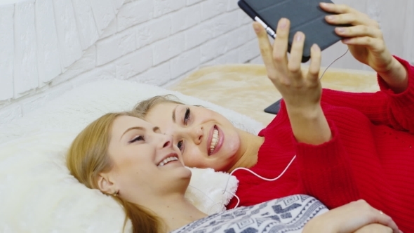 Two Young Girls Communicate With Tablet