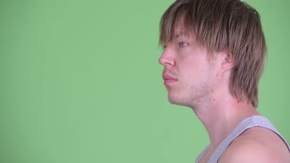 Closeup Profile View of Young Man with Messy Hair Thinking