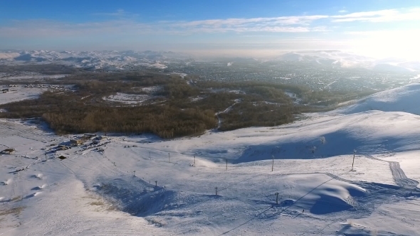 Aerial Shot Of Ski Resort, Mountains, And Town.