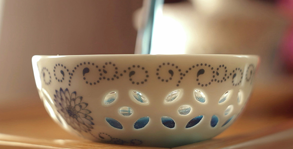 Man Poured Thailand Blue Tea into a Porcelain Bowl and Take It
