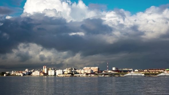 Fluffy Clouds Over City And Ferry Terminal