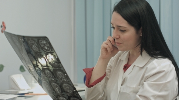 Beautiful Female Doctor Talking On Cellphone At Modern Hospital Indoors