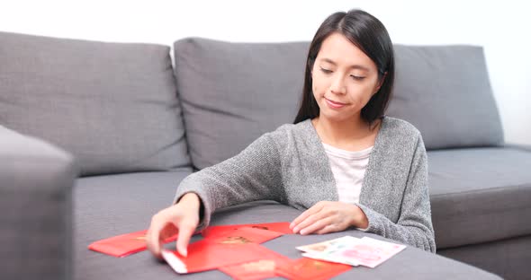 Woman Putting Money Into Chinese Red Packet