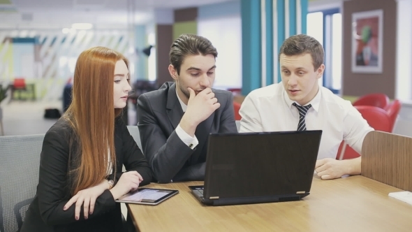 Three Business People Meeting In Office